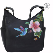 Load image into Gallery viewer, Anuschka style 382, handpainted Classic Hobo With Side Pockets. Hummingbird painting in Black color. Fits Tablet and E-Reader.
