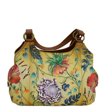 Load image into Gallery viewer, Anuschka style 652, handpainted Triple Compartment Large Satchel. Caribbean Garden Painted in Tan Color. Featuring two full length outer compartments with magnetic closure, rear has zippered pocket, slip in cell pocket, removable fabric optical case, cosmetic pouch and metal logo keycharm.
