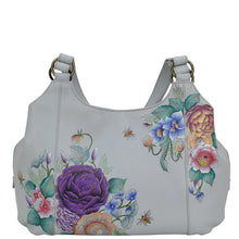 Load image into Gallery viewer, Anuschka style 652, handpainted Triple Compartment Large Satchel. Floral Charm painting in grey color. Fits Tablet and E-Reader. Removable fabric optical case, cosmetic pouch and metal logo keycharm.
