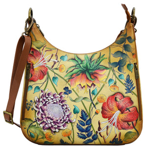 Anuschka style 662, handpainted Convertible Slim Hobo With Crossbody Strap. Caribbean Garden Painted in Tan Color. Featuring inside zippered wall pocket, one open wall pocket, two multipurpose pockets with gusset and rear full length zippered pocket, slip in cell pocket.