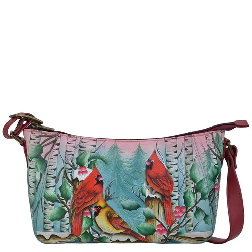 Anuschka style 670, handpainted Everyday Shoulder Hobo. Snowy Cardinal Painted in Multi Color. Featuring inside one zippered wall pocket, two multipurpose pockets, rear full length zippered pocket with adjustable shoulder strap.