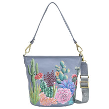 Load image into Gallery viewer, Anuschka style 699, Handpainted Tall Bucket Hobo. Desert Garden painting in grey color. Featuring Rear full length zip pocket, slip in cell pocket.

